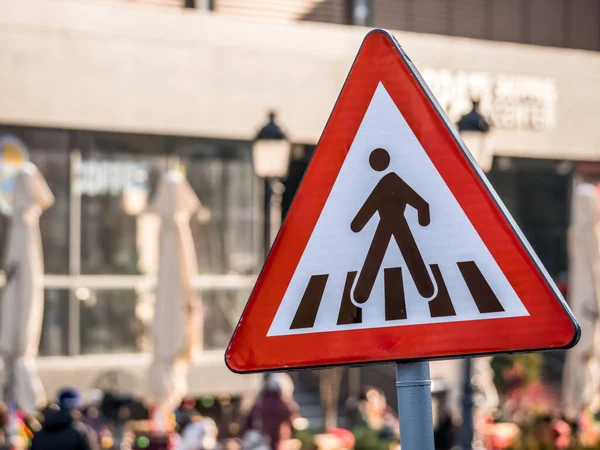 Pedestrian crossing traffic sign. Red triangle and a man crossing the street.