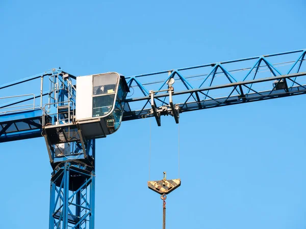 Close up details with a cabin control of a construction crane.Turret Slewing Crane against blue sky