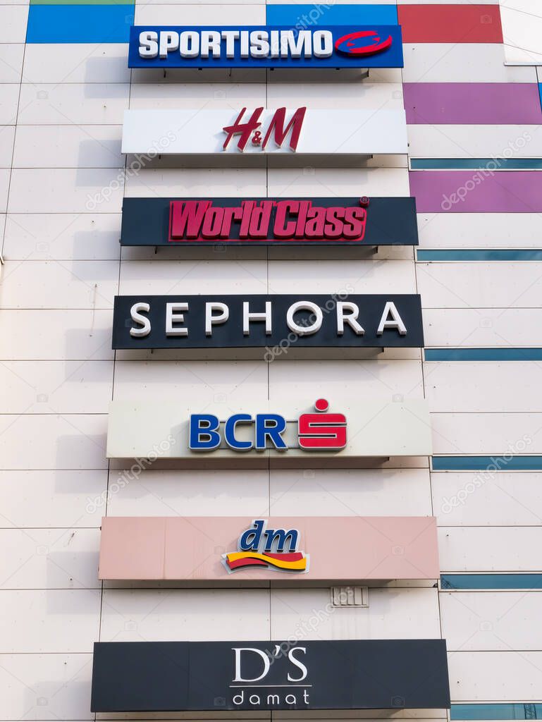Bucharest, Romania - 02.13.2021: Plaza Romania shopping mall facade with many logos of companies. Mall with clothing, electronics and food stores