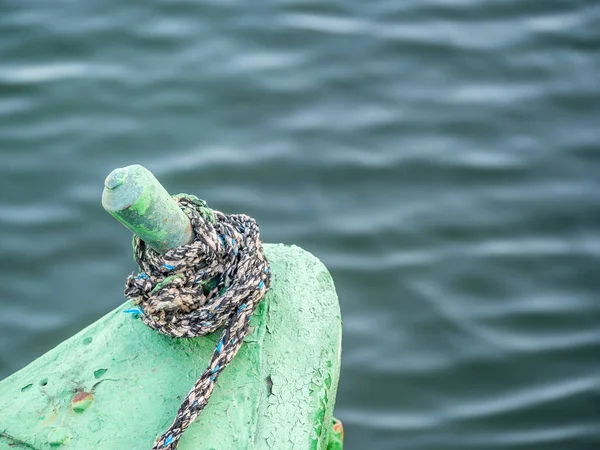Sail boat rope tied to a bitt mooring bollard