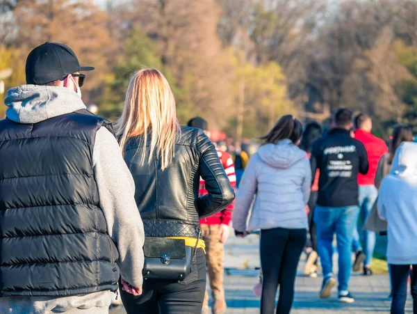 Many people out for a walk or stroll in King Mihai I Park (herestrau). Busy day in the park