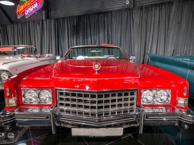 Bükreş, Romanya - 05.14.2021: 1973 yılından kırmızı bir Cadillac Eldorado ile ön manzara
