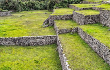 Machu Picchu, Peru 'daki antik İnka taş duvarları ve teraslarıyla yakın çekim..
