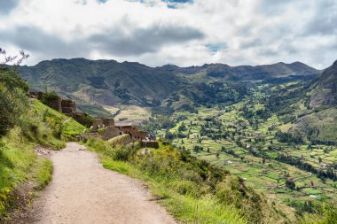 Pisac, Peru - March 20, 2025: Group of tourists at a scenic view point overlooking the Sacred Valley, at Pisac archaeological site