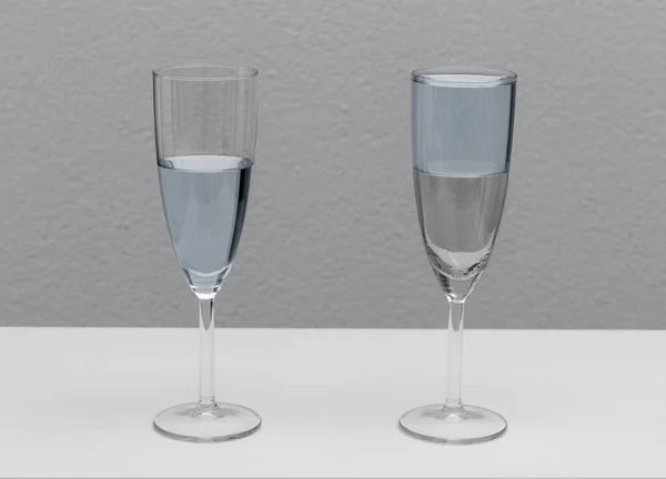 Glass half full or half empty showing optimistic or pessimistic attitude. —  Fotos de Stock