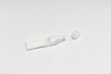 Plastic eyedrop container against white background. Concept of dry eyes or allergy against pollen