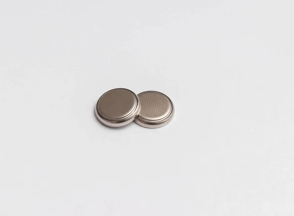 two button cell or disk cell batteries isolated on white background