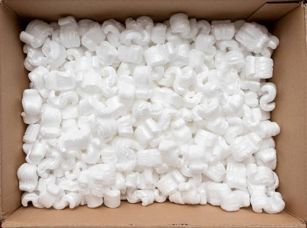 A cardboard box with packing styro foam pellets top view — Stock Photo, Image