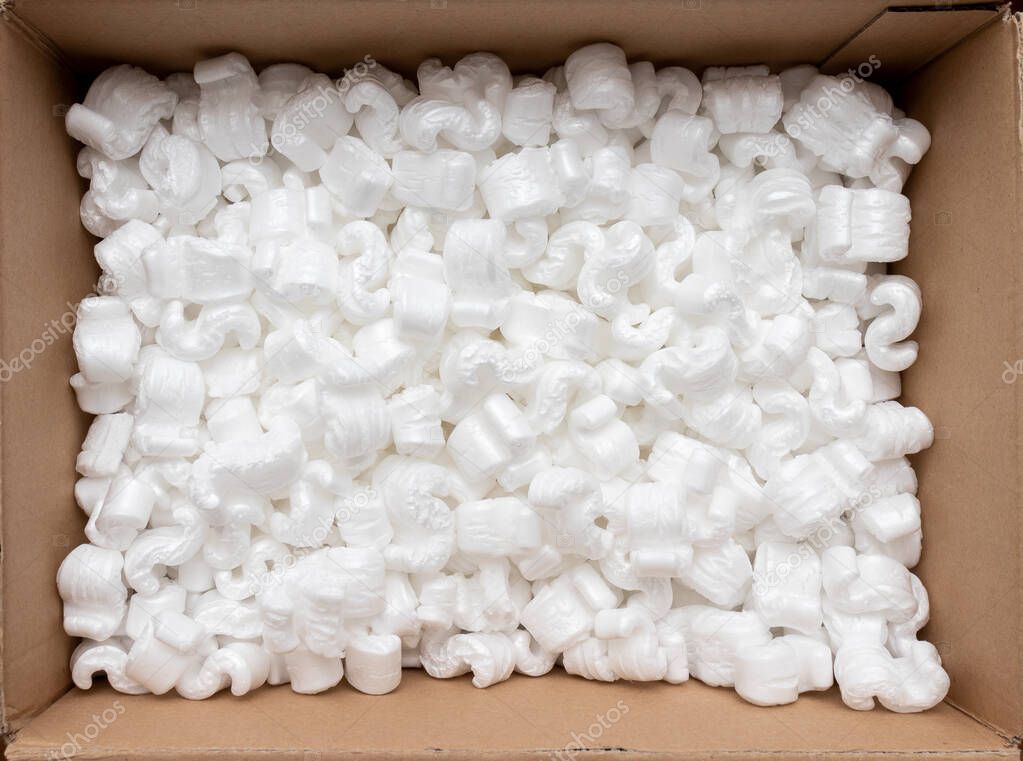 A cardboard box with packing styro foam pellets top view