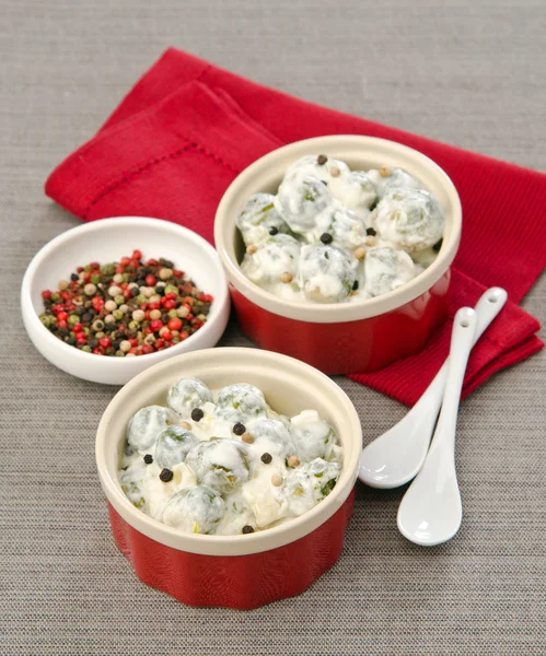 Mushrooms in cream sauce in a cocotte — Stock Photo, Image