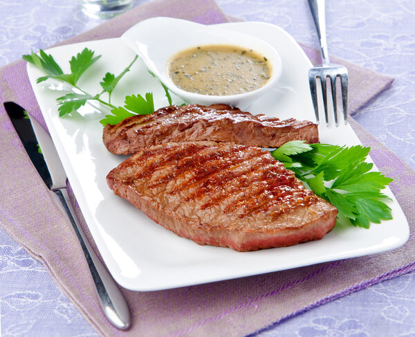 grilled steak on a white plate