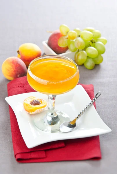Fruit jelly with peaches and grapes — Stock Photo, Image
