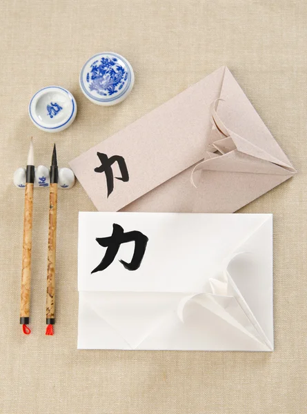 Envelope with origami lily hieroglyph force — Stock Photo, Image