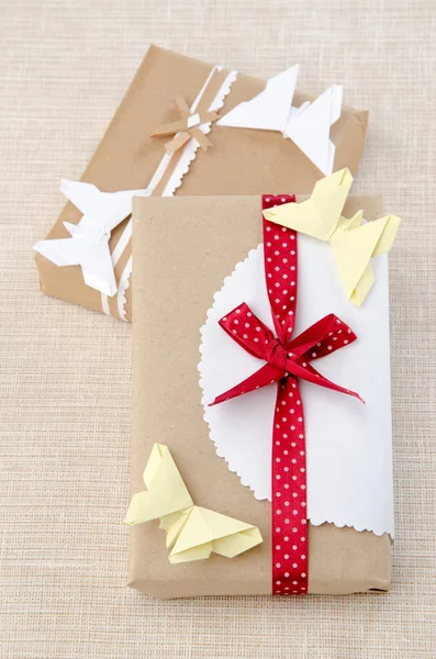 Origami butterfly on a box with a gift — Stock Photo, Image