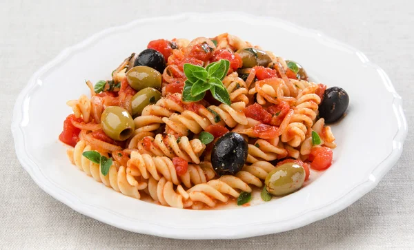 Fusilli with tomato olives and oregano — Stock Photo, Image