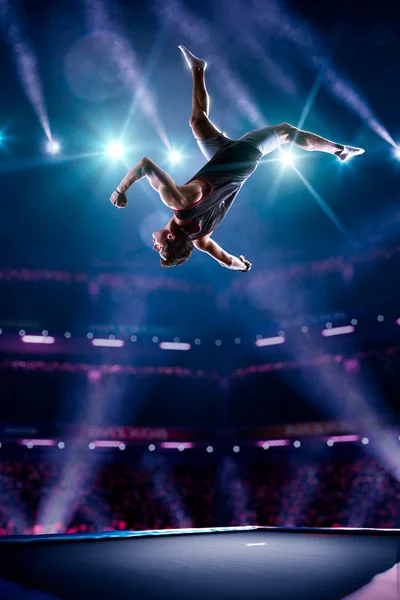 Young man is jumping on trampoline — Stock Photo, Image