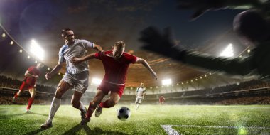 Soccer players in action on sunset stadium background panorama clipart