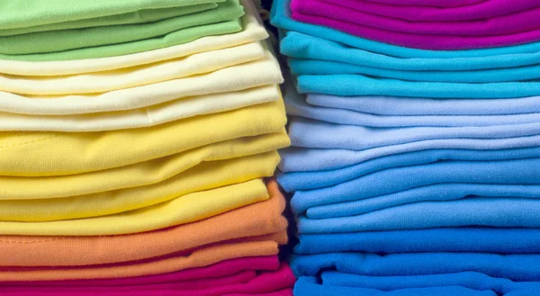 Pile of bright folded t-shirts — Stock Photo, Image