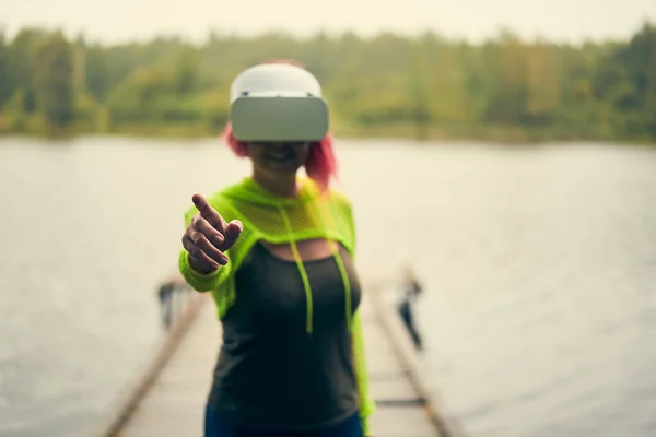 Woman goes into virtual reality using virtual reality headset.