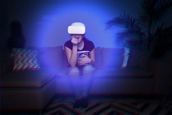 Woman watching movie at home using vr headset