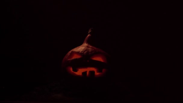 Calabaza con la boca y los ojos ardientes parpadeantes. Celebración Halloween. Video 4k. — Vídeo de stock