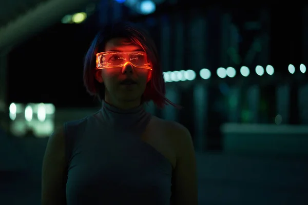 Cyberpunk style portrait of beautiful young woman in futuristic costume. — Stock Photo, Image