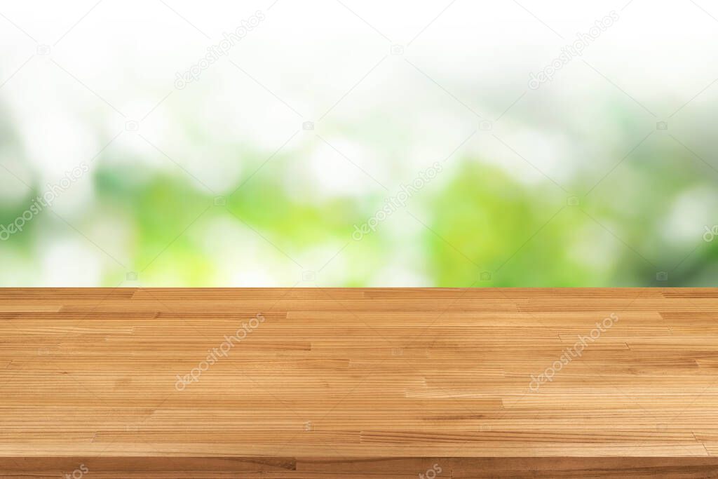 light brown wood table on green blurred bokeh background