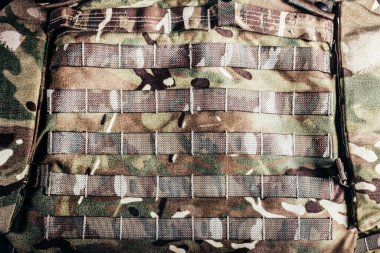 Photo of military camouflaged armored vest molle system. clipart