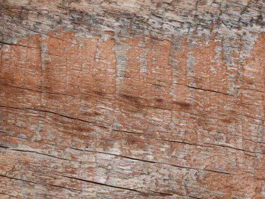 Boya ve çatlaklarla aşınmış ahşap bir kalas resmi..