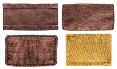 Beyaz arkaplanda dikişli kahverengi renkli kumaş parçalarının izole edilmiş fotoğrafı.