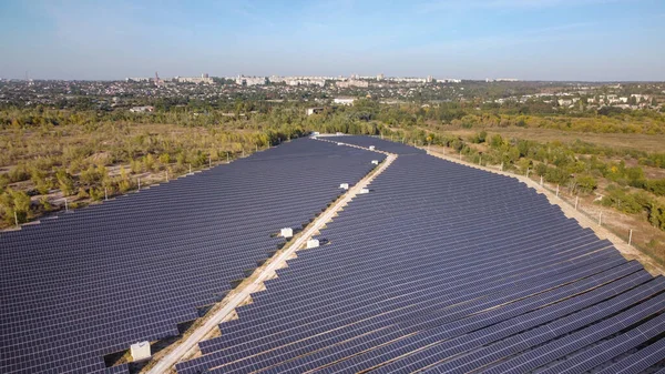 Solar energy farm. High angle, elevated view of solar panels on an energy farm far from city. aerial view