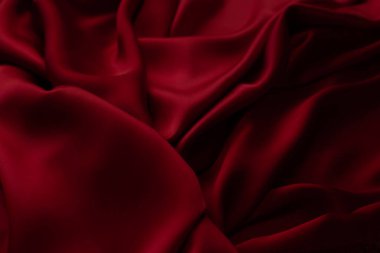 Kırmızı pürüzsüz kumaş dokuyu katlar. Lüks saten kumaş..