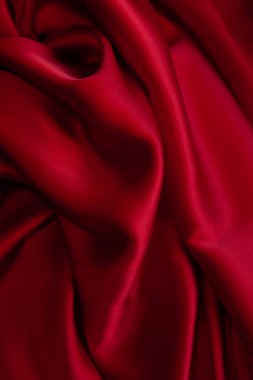 Kırmızı kumaş dokusu arka plan. İpek saten katlanır. Pürüzsüz, zarif duvar kağıdı.