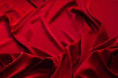 Kırmızı kumaş dokusu arka plan. İpek saten katlanır. Pürüzsüz, zarif duvar kağıdı.