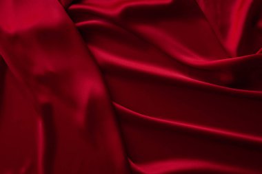 Kırmızı kumaş dokusu arka plan. İpek saten katlanır. Pürüzsüz, zarif duvar kağıdı.