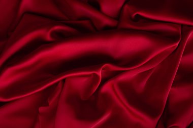 Kırmızı kumaş dokusu arka plan. İpek saten katlanır. Pürüzsüz, zarif duvar kağıdı.