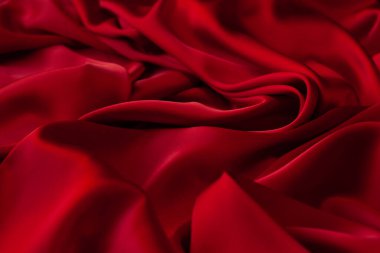 Kırmızı kumaş dokusu arka plan. İpek saten katlanır. Pürüzsüz, zarif duvar kağıdı.