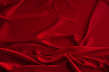 Kırmızı kumaş dokusu arka plan. İpek saten katlanır. Pürüzsüz, zarif duvar kağıdı.