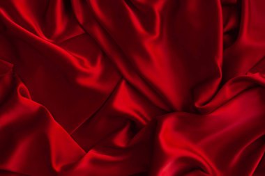Kırmızı kumaş dokusu arka plan. İpek saten katlanır. Pürüzsüz, zarif duvar kağıdı.