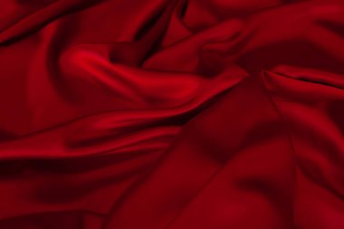 Kırmızı kumaş dokusu arka plan. İpek saten katlanır. Pürüzsüz, zarif duvar kağıdı.