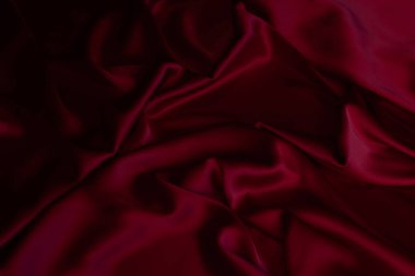 Kırmızı pürüzsüz kumaş dokuyu katlar. Lüks saten kumaş..