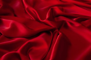Kırmızı kumaş dokusu arka plan. İpek saten katlanır. Pürüzsüz, zarif duvar kağıdı.