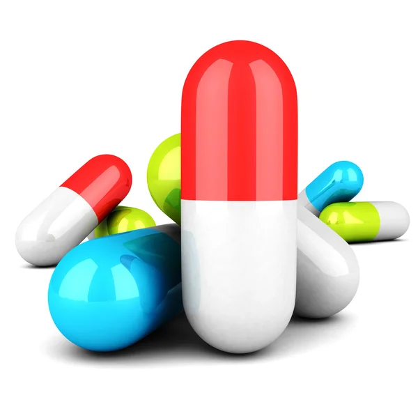 Pillole mediche colorate su sfondo bianco — Foto Stock
