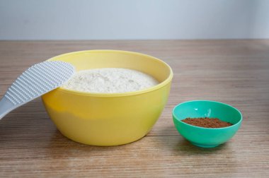 Mutfak masasında bir kase un ve kakao var.