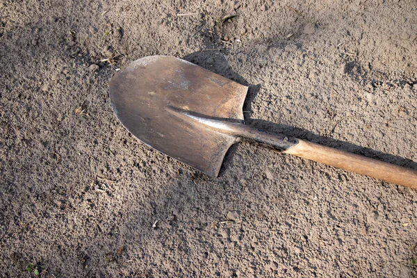 Digging spring soil with shovel. Close-up. Shovel on the ground, concept of gardening.