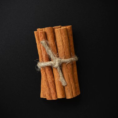 Tarçın çubukları koyu arka planda izole edilmiş, seçici odaklı.