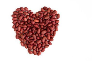 Beyaz arka planda kalp şeklinde yapılmış yer fıstığı. Üst Manzara. Düz yatıyordu. Sevgililer Günü. Aşıkların sembolü.