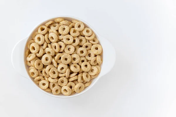 白い背景に隔離されたボウルにシリアルチエリオス おいしいリングのプレート 健康的な朝食のコンセプト — ストック写真