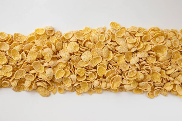 corn flakes background, frame of cornflakes isolated on white background, close up, side view