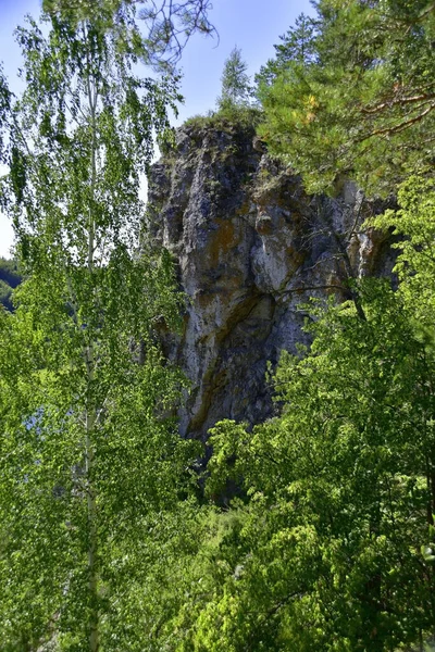 Gypsum rocks on top of the Ermak stone in the Kungur region of the Perm region. Below the river Sylva and the village of Chikali